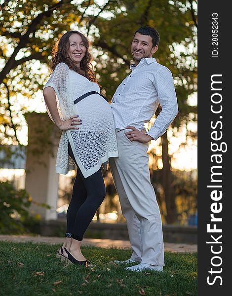 Pregnant couple resting in the park