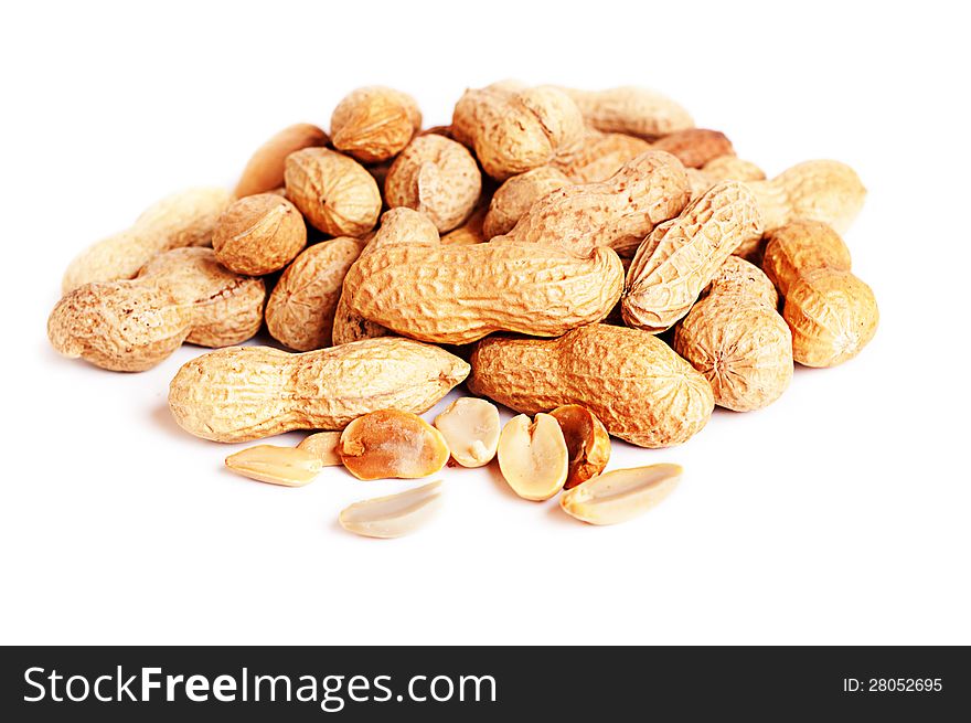 Pile of groundnuts on a white background