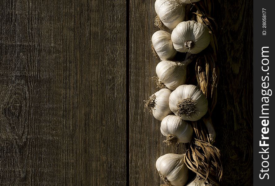 Bunch of garlic on a wooden table.