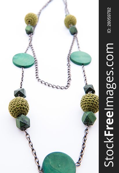 Green beads necklace on a white background