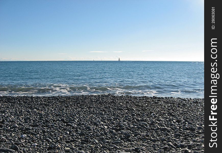 Rocky beach with calm sea and clear sky. Rocky beach with calm sea and clear sky