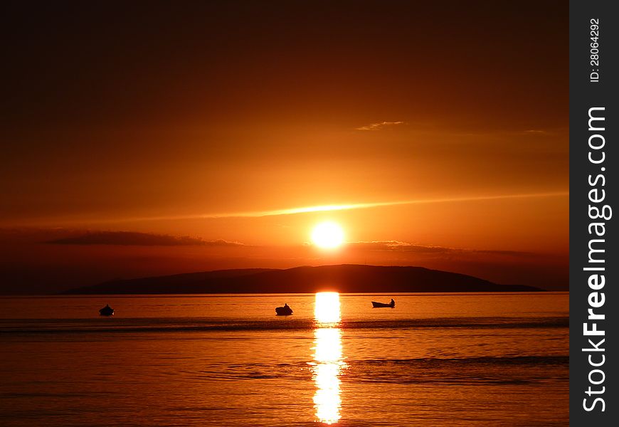 Sunset in Croatia with fishermen.