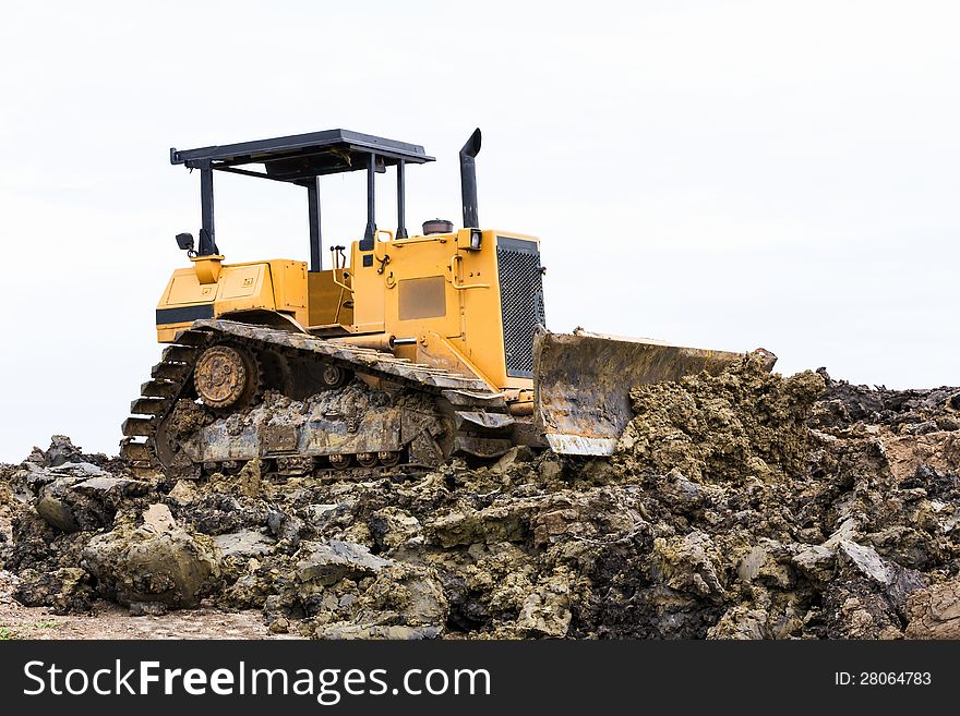 Bulldozer machine doing earth moving work in construction site. Bulldozer machine doing earth moving work in construction site