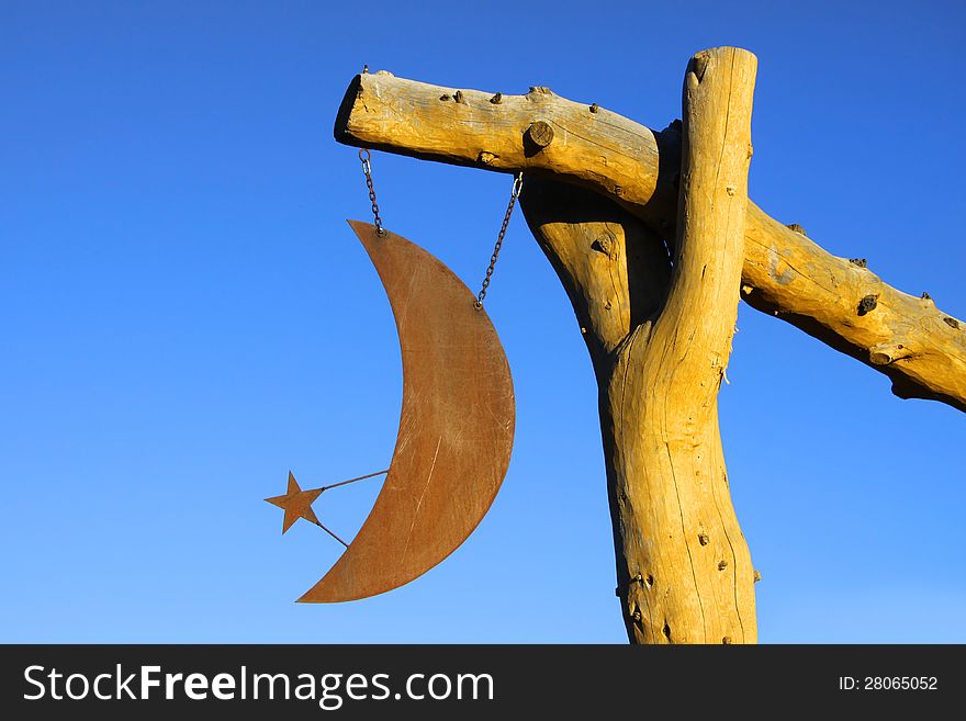 Moon and star metal ornament hanging from the pole. Moon and star metal ornament hanging from the pole