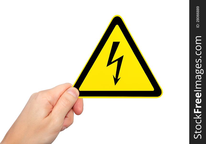 Isolated male hand holding yellow sign of danger high voltage symbol with lightning. Isolated male hand holding yellow sign of danger high voltage symbol with lightning