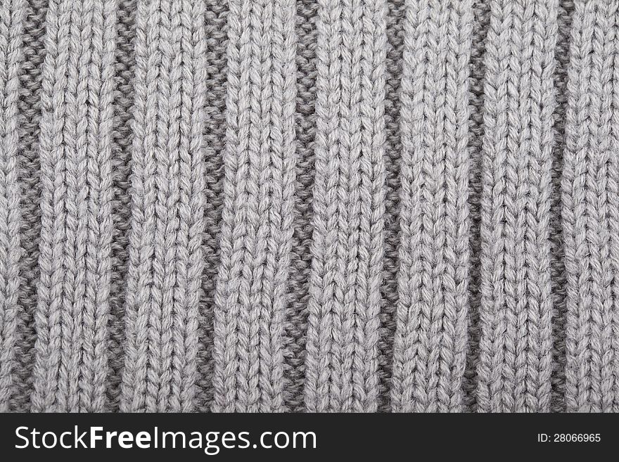 Gray knitted polosany material for use as a background. Gray knitted polosany material for use as a background