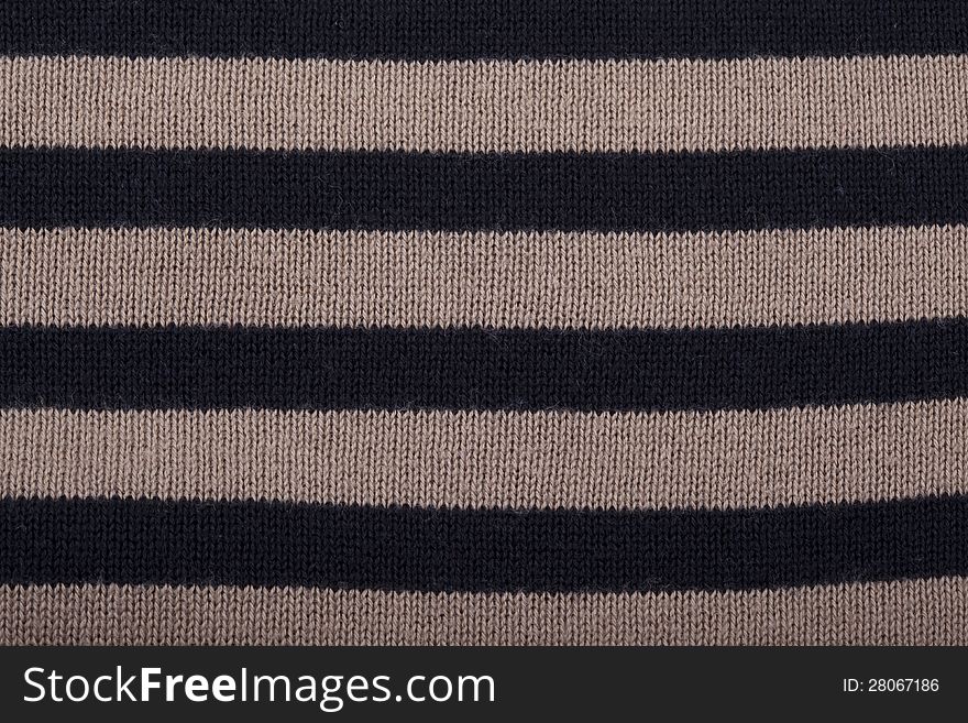 Knitted background with black and brown stripes