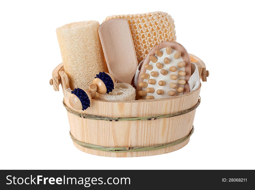 Massage and sauna supplies in a wooden bucket - isolated. Massage and sauna supplies in a wooden bucket - isolated