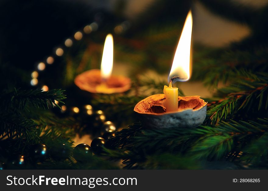 Arrangement of two burning candles and pearls and coniferous sprigs. Arrangement of two burning candles and pearls and coniferous sprigs