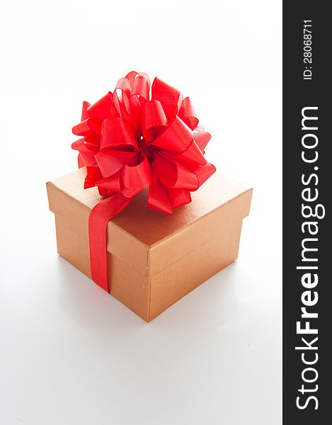 Brown gift box for Christmas with a red bow