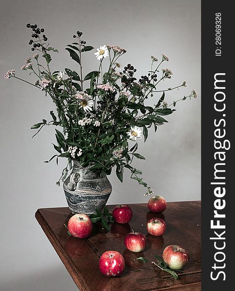 Autumn still life with apple and flowers
