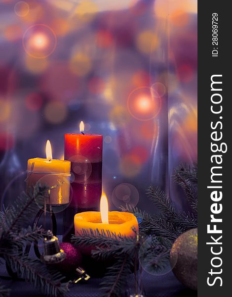 Candles with Christmas balls in atmospheric light