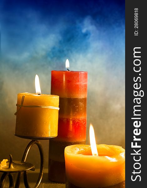 Candles  in atmospheric light on blue background