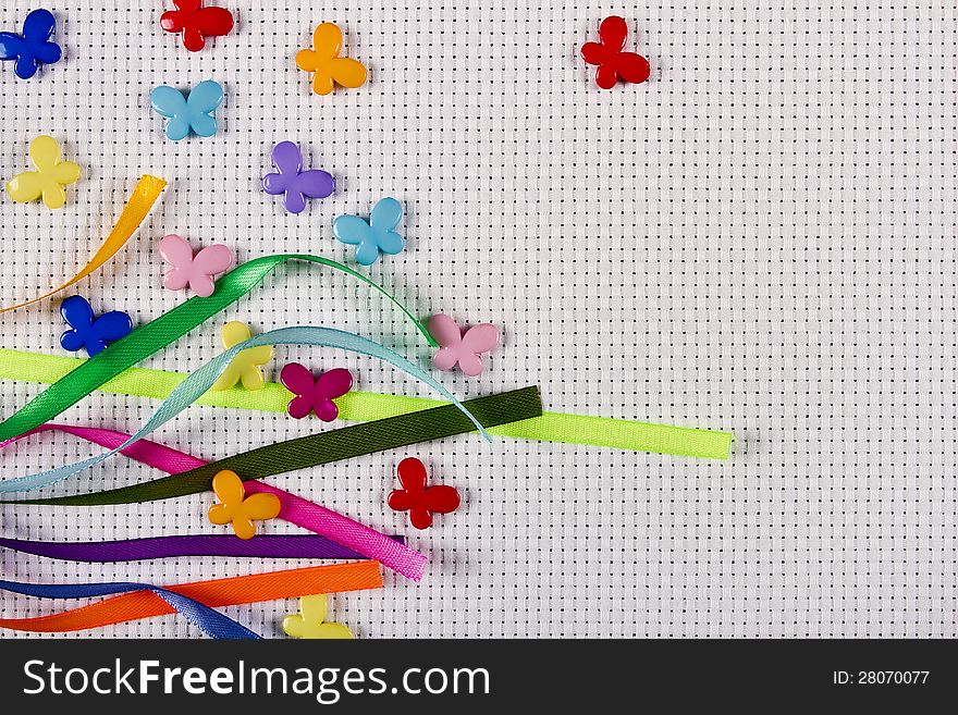 White canvas decorated with coloured ribbons and butterflies. White canvas decorated with coloured ribbons and butterflies