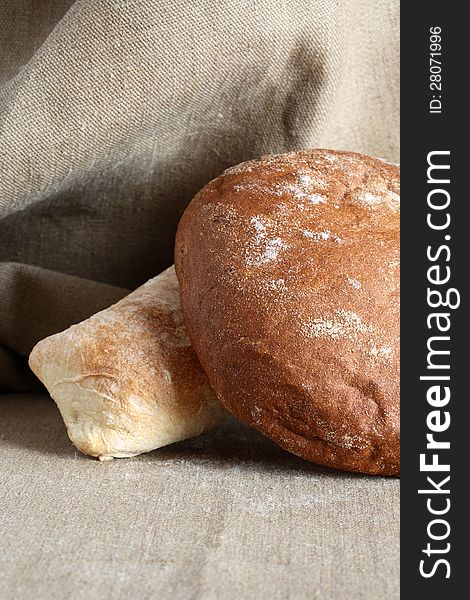 Rye and wheat bread on canvas background