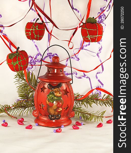 The red lantern with conifer branch, beads and apples