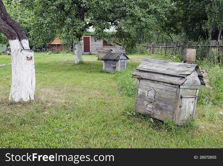 Summer lawn with vintage wooden beehives. Summer lawn with vintage wooden beehives