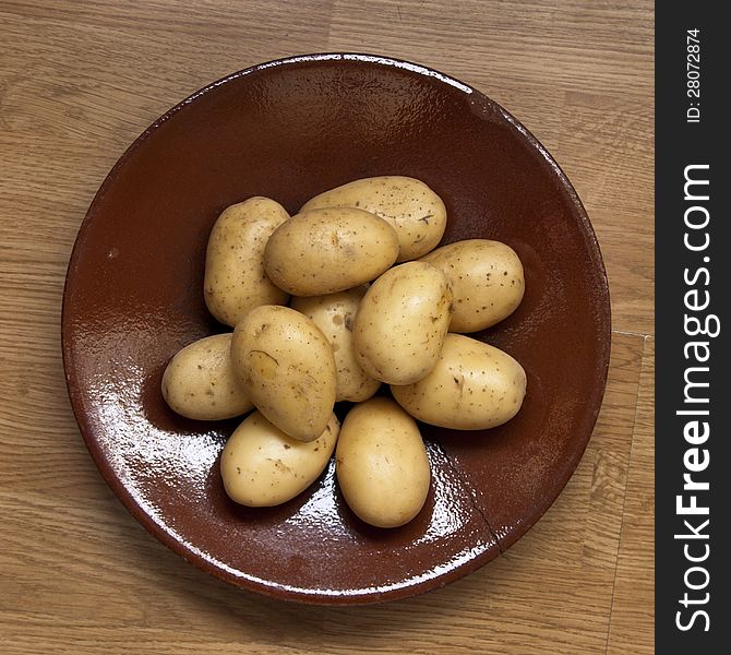 Potatoes on old brown ceramic plate. Potatoes on old brown ceramic plate