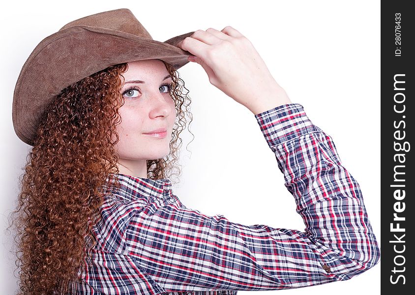 Portrait of pretty girl in a cowboy hat on a light background