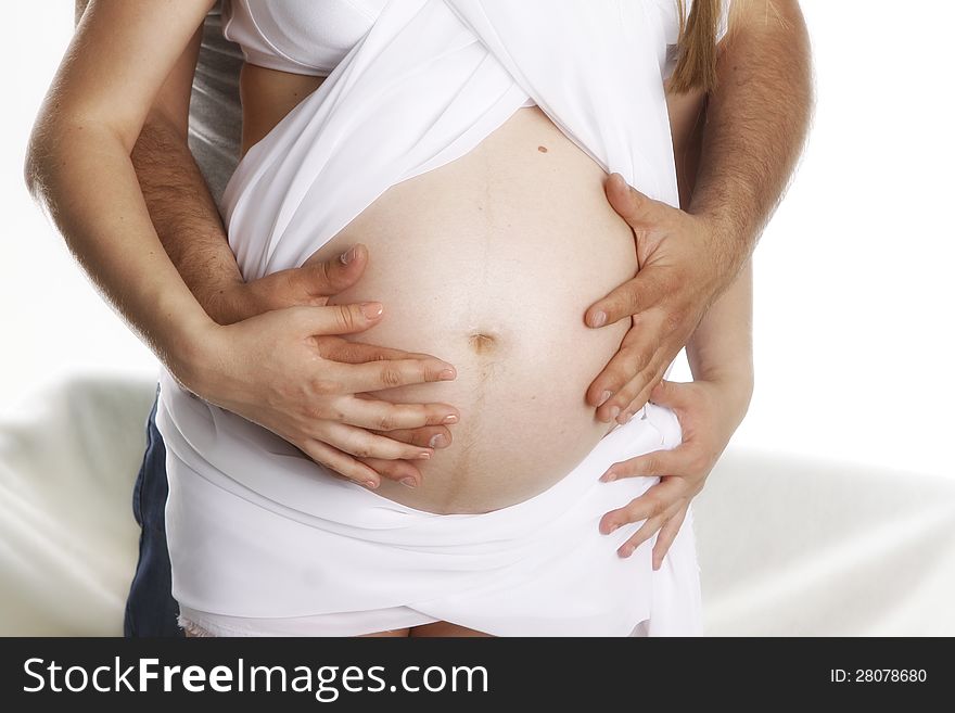 Husband embraces a stomach to the pregnant wife. Husband embraces a stomach to the pregnant wife