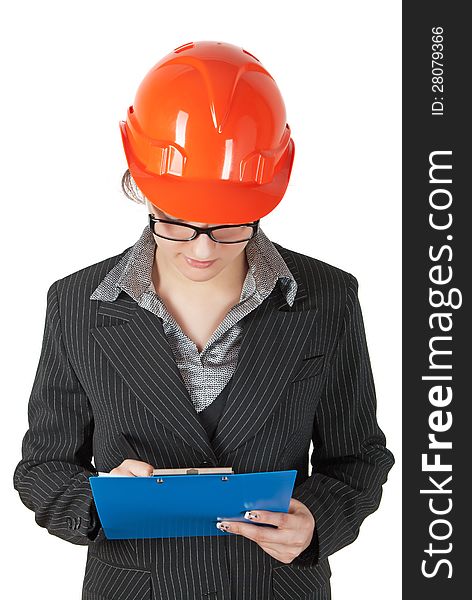 Female superintendent in the construction helmet records the tablet