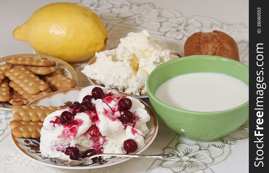 Cottage cheese with sour cream and cranberry berries, cookies and milk for a breakfast