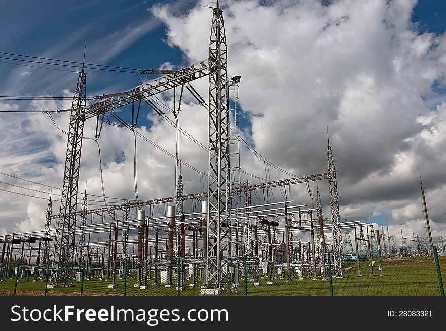 Electric power station in the countryside against a cloudy sky. Electric power station in the countryside against a cloudy sky