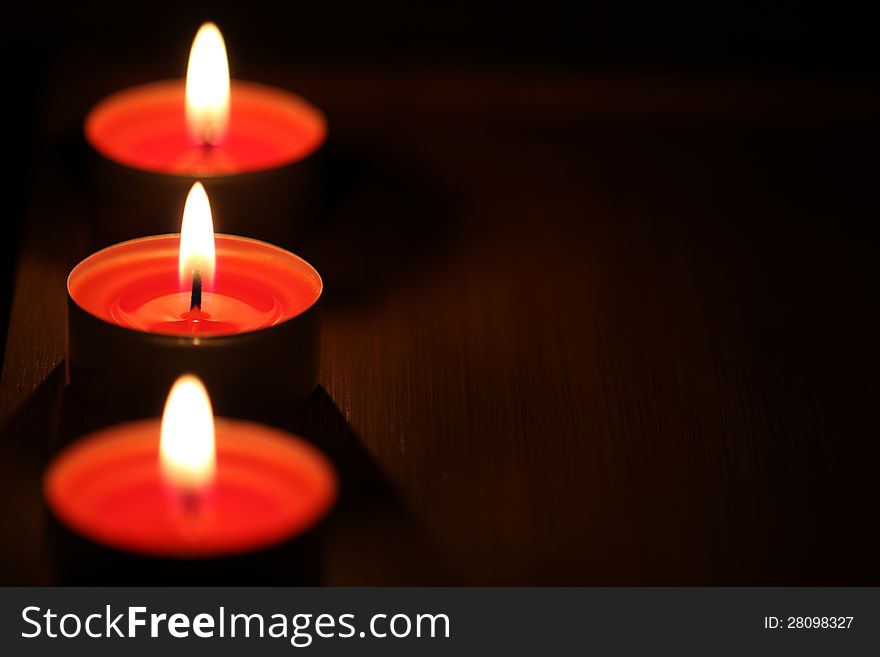 Red candles on dark background