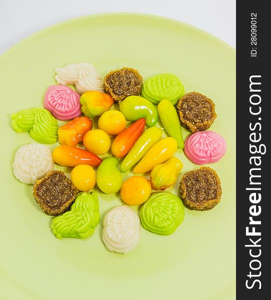 Various colorful Thai dessert on green plate