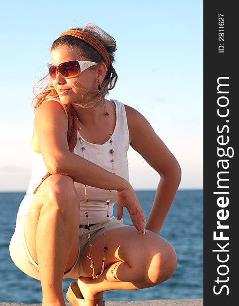 Young girl wearing sunglasses at sunset. Young girl wearing sunglasses at sunset