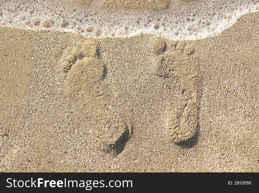 Two men's footprints on the sand. Two men's footprints on the sand