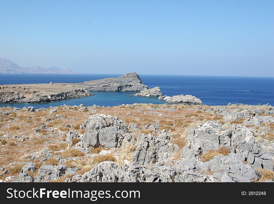 Rocky terrain along coastline of greek island of rhodes, city of lindos. Rocky terrain along coastline of greek island of rhodes, city of lindos