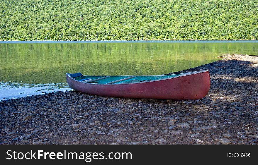 Red canoe on the shore of Canadice Lake, New York