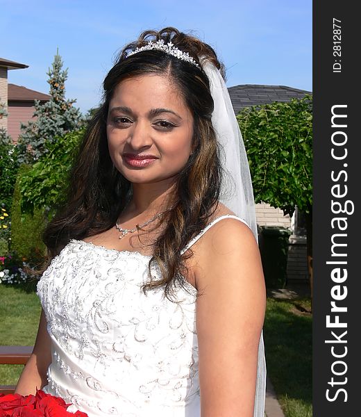 An outside portrait of the young bride before the ride in the limo to church. An outside portrait of the young bride before the ride in the limo to church.