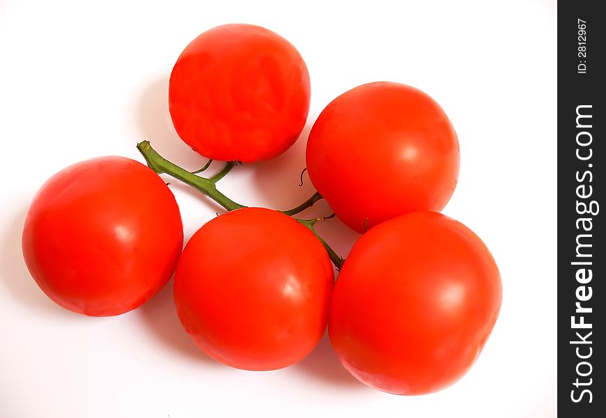 A bunch of ripe red tomatoes still together on the stem on white background.