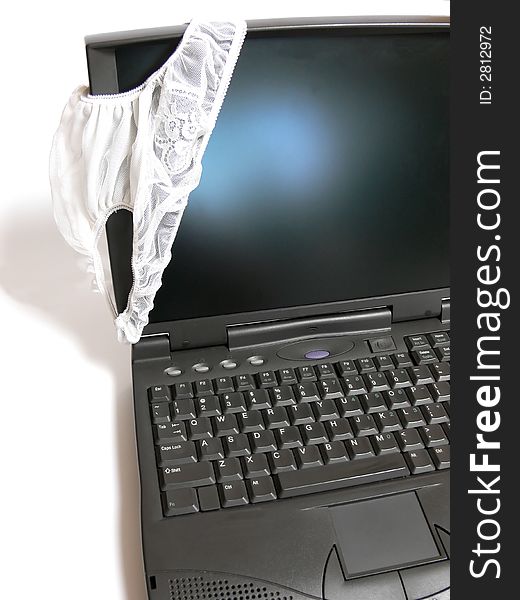 A laptop on white background is decorated with a white pantie. A laptop on white background is decorated with a white pantie.