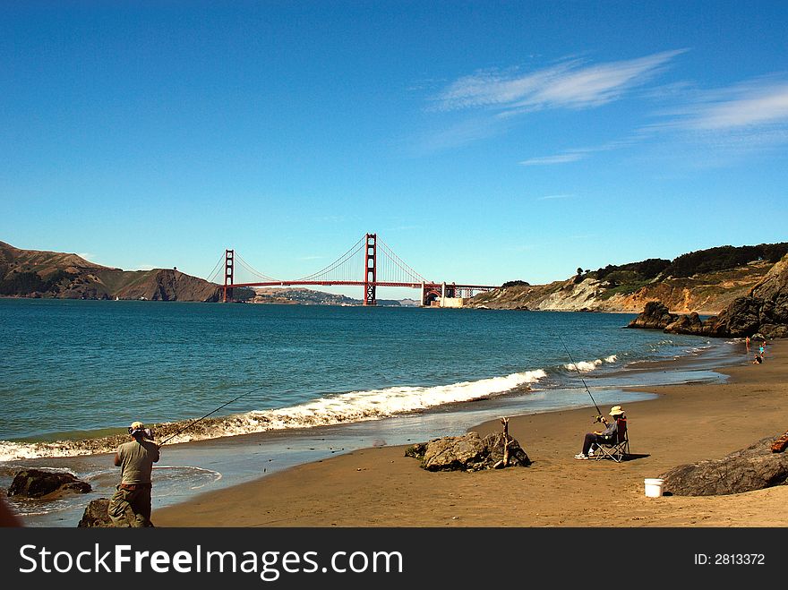 Fishermen enjoying a beautiful summer day at a local beach with Golden Gate bridge in the background. Fishermen enjoying a beautiful summer day at a local beach with Golden Gate bridge in the background