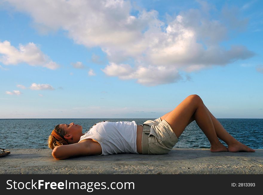 Young girl relaxing by the ocean