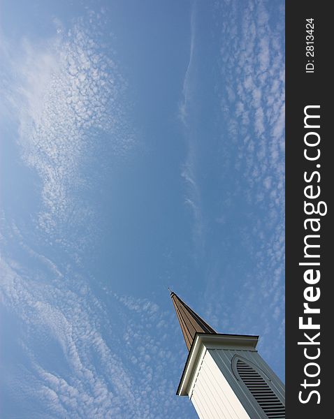 Church steep with blue sky and cirrus clouds, ample room for text. Church steep with blue sky and cirrus clouds, ample room for text