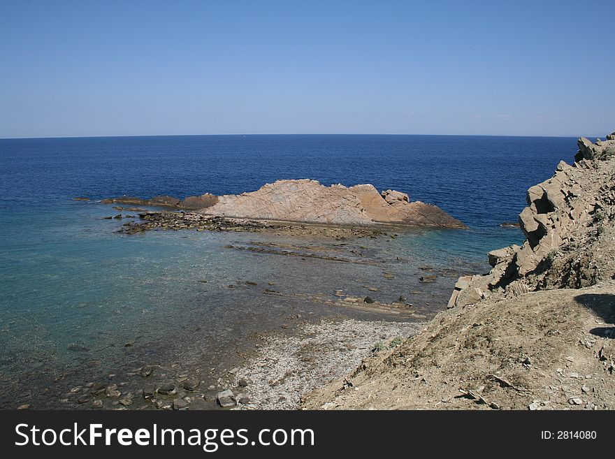 Calm and peaceful rocky coast with island. Calm and peaceful rocky coast with island