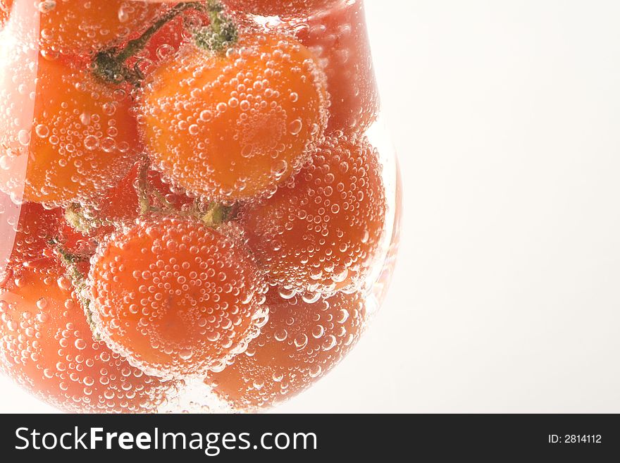 Red fresh tomatos are in the water