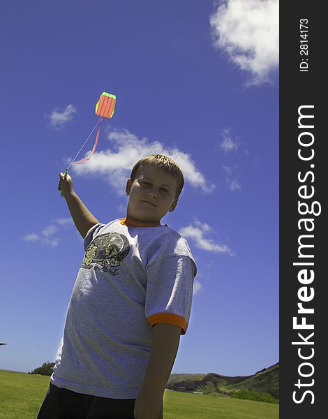 Young boy flies his kite. Young boy flies his kite.