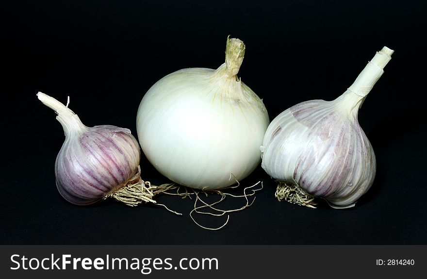 Garlic and onion on the black background