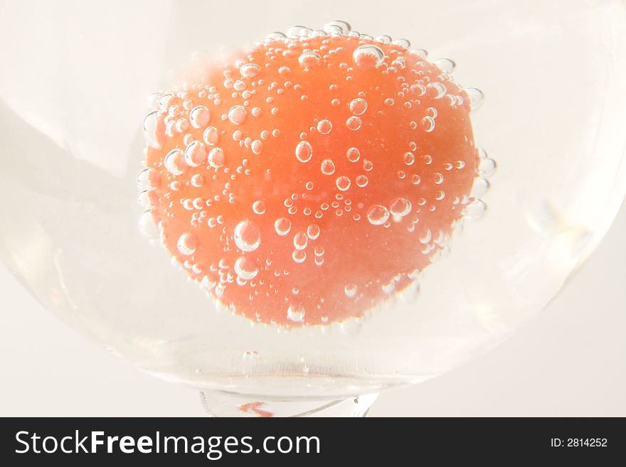 Red fresh tomato in water