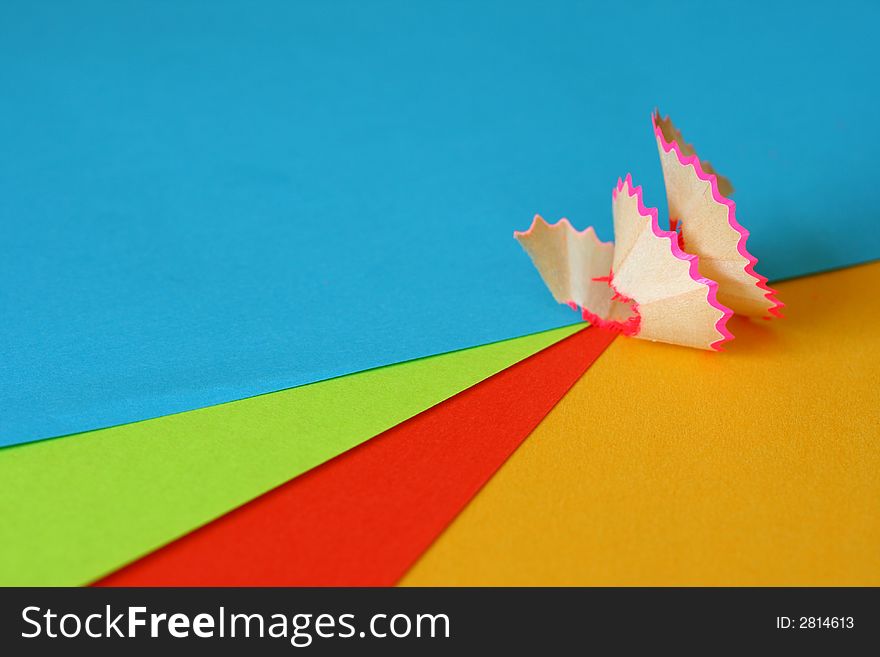 Close up of a coloured pencil shaving on coloured paper to add impact. Close up of a coloured pencil shaving on coloured paper to add impact