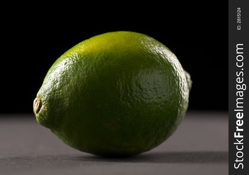 Single lime with a black background