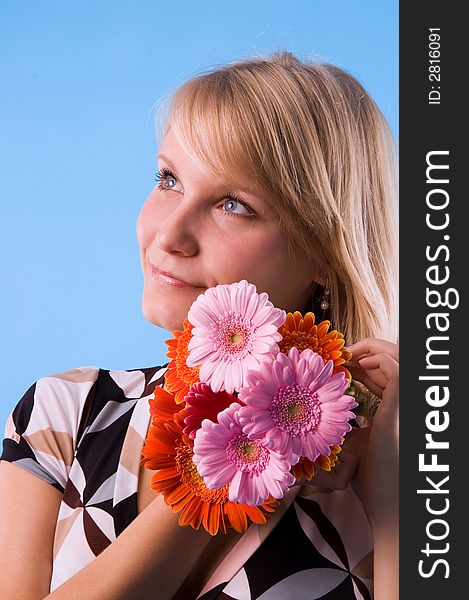 The girl looks atop of a beautiful bouquet of flowers. The girl looks atop of a beautiful bouquet of flowers