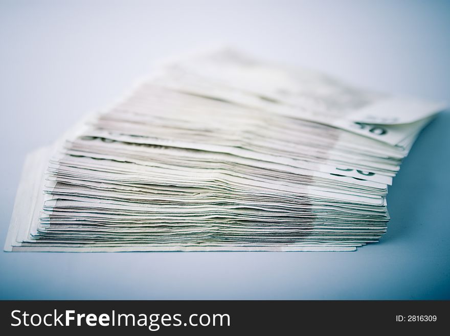 Pile of fifty euro banknotes on blue background. Pile of fifty euro banknotes on blue background.