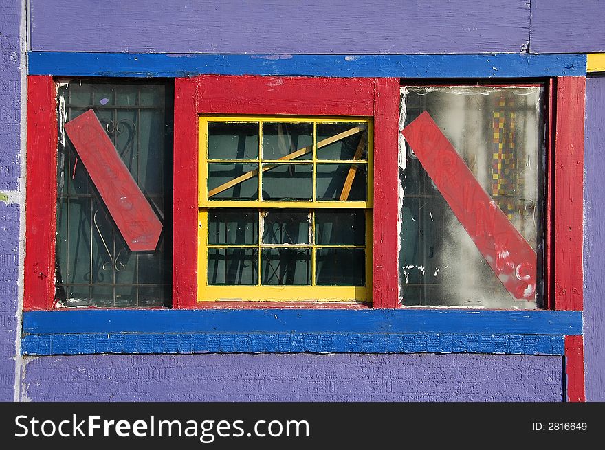 A brightly colored window of an abandoned urban day care center. A brightly colored window of an abandoned urban day care center