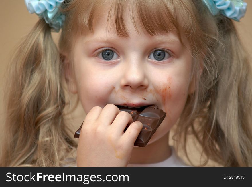 A girl eating a chocolate